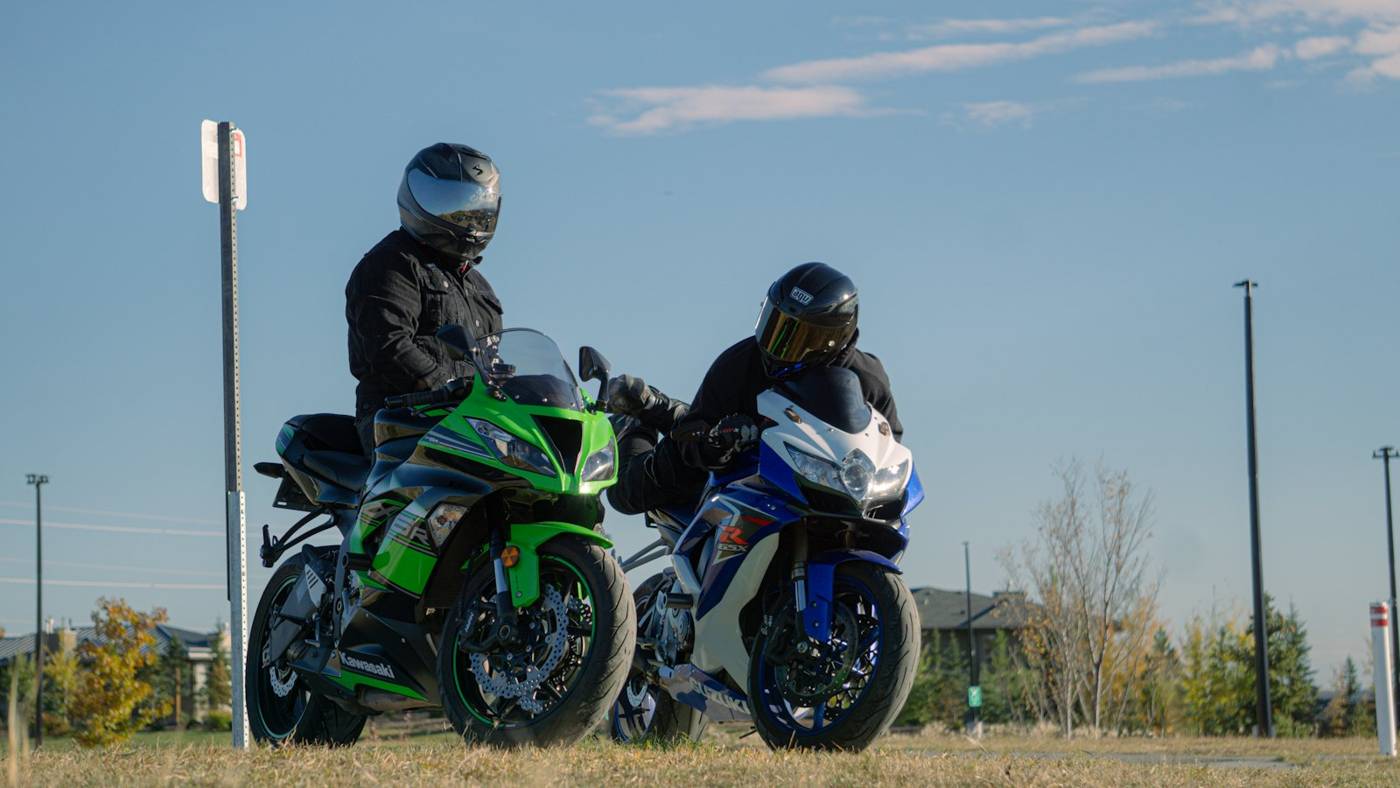 Riding buddies Two friends sitting on their sport motorcycles in a parking lot